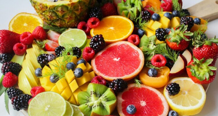 A vibrant assortment of fresh fruits beautifully arranged on a platter, perfect for a healthy and delicious snack.